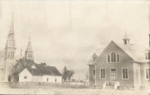 Black and white photo showing the school (right), parish hall (center) and church (left).